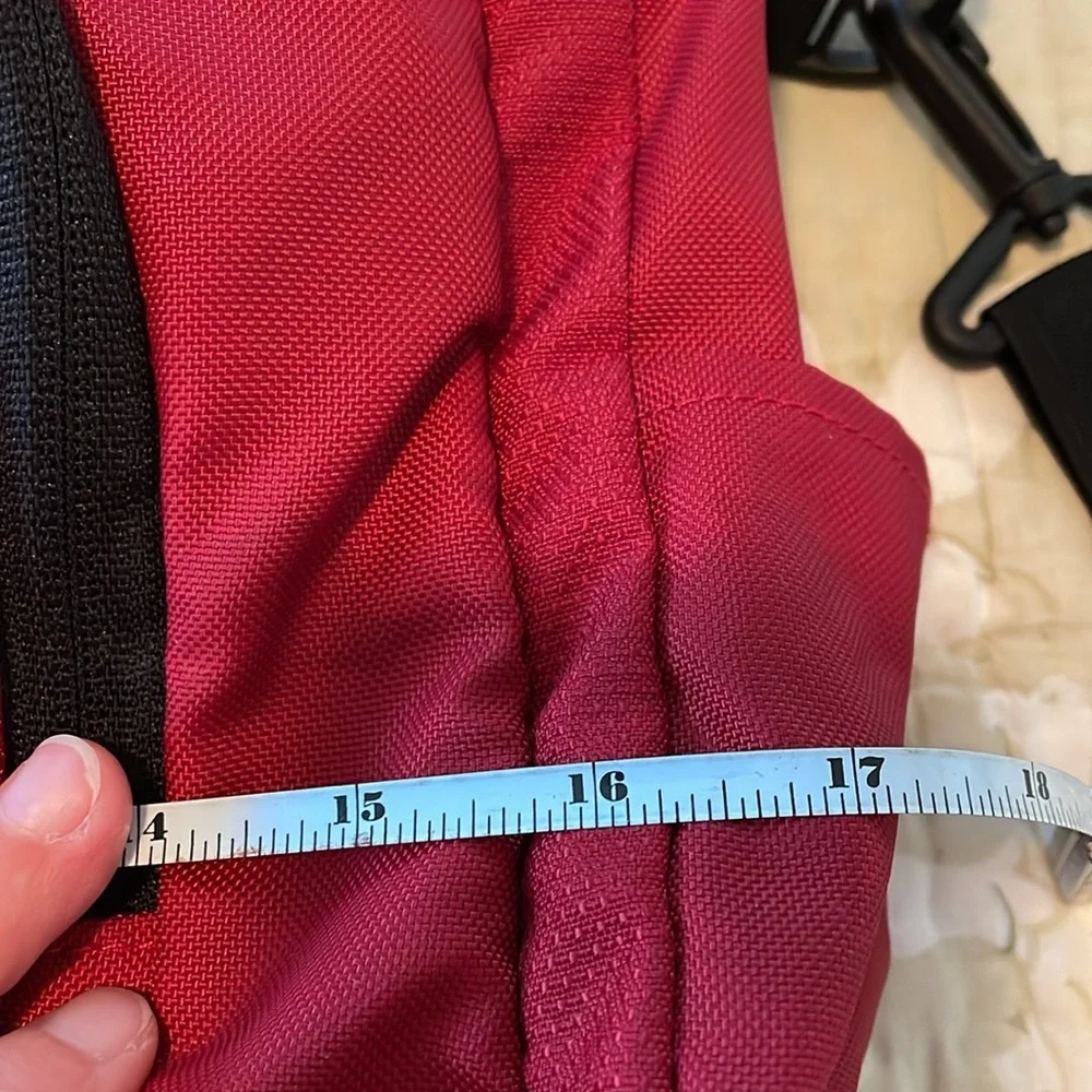 Red Jansport laptop messenger bag. Interior Velcro & outer zippered compartment